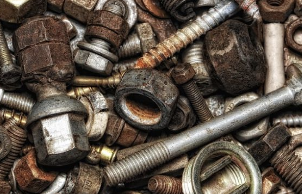 A close-up of many rusty nuts and bolts